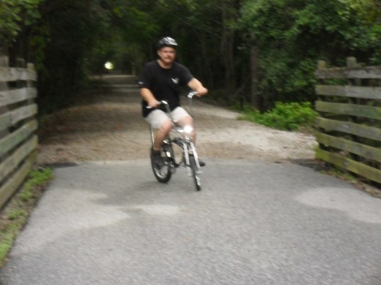Here we have a large man on a small bicycle! Having loads of fun too.