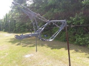 <motorcycle frame on clothes line>